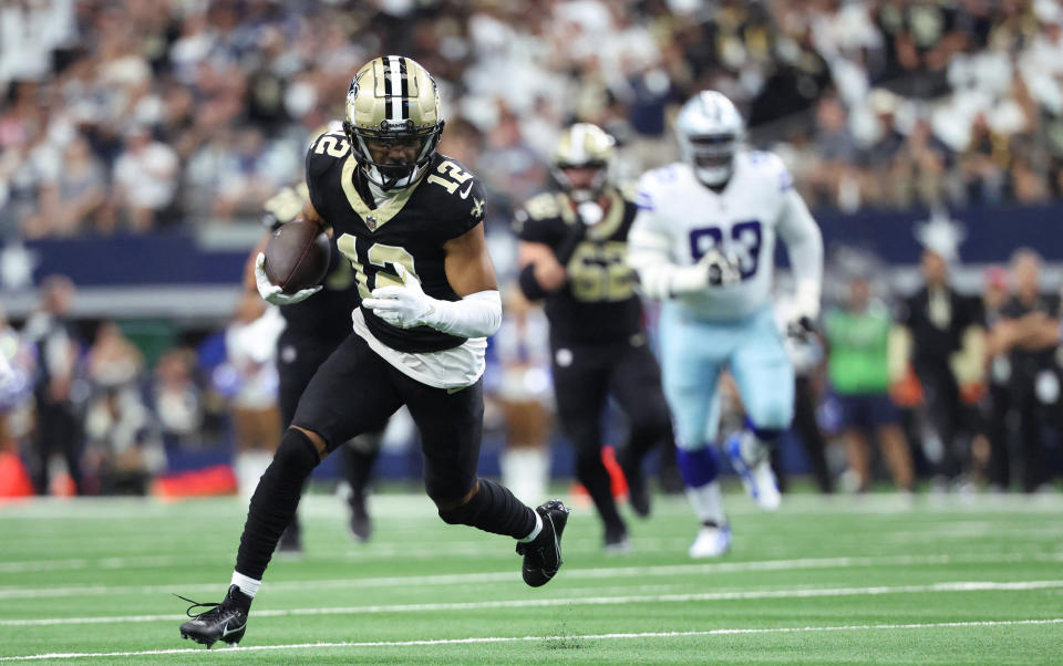 Sep 15, 2024; Arlington, Texas, USA;  New Orleans Saints wide receiver Chris Olave (12) runs with the ball during the first half against the Dallas Cowboys at AT&T Stadium. Mandatory Credit: Kevin Jairaj-Imagn Images