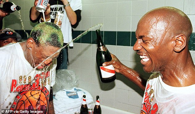 Jordan sprays champagne over team-mate Dennis Rodman after winning the NBA title