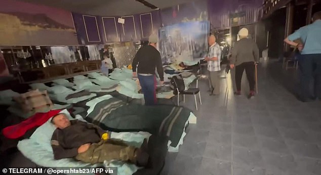 Evacuees resting in an emergency shelter after their evacuation from an area targeted by a Ukrainian drone on September 21