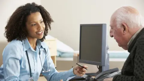 Getty Images Patient chatting with their family doctor