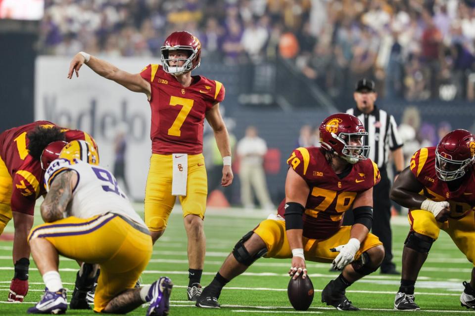 USC quarterback Miller Moss signals a play while Jonah Monheim lines up to snap the ball