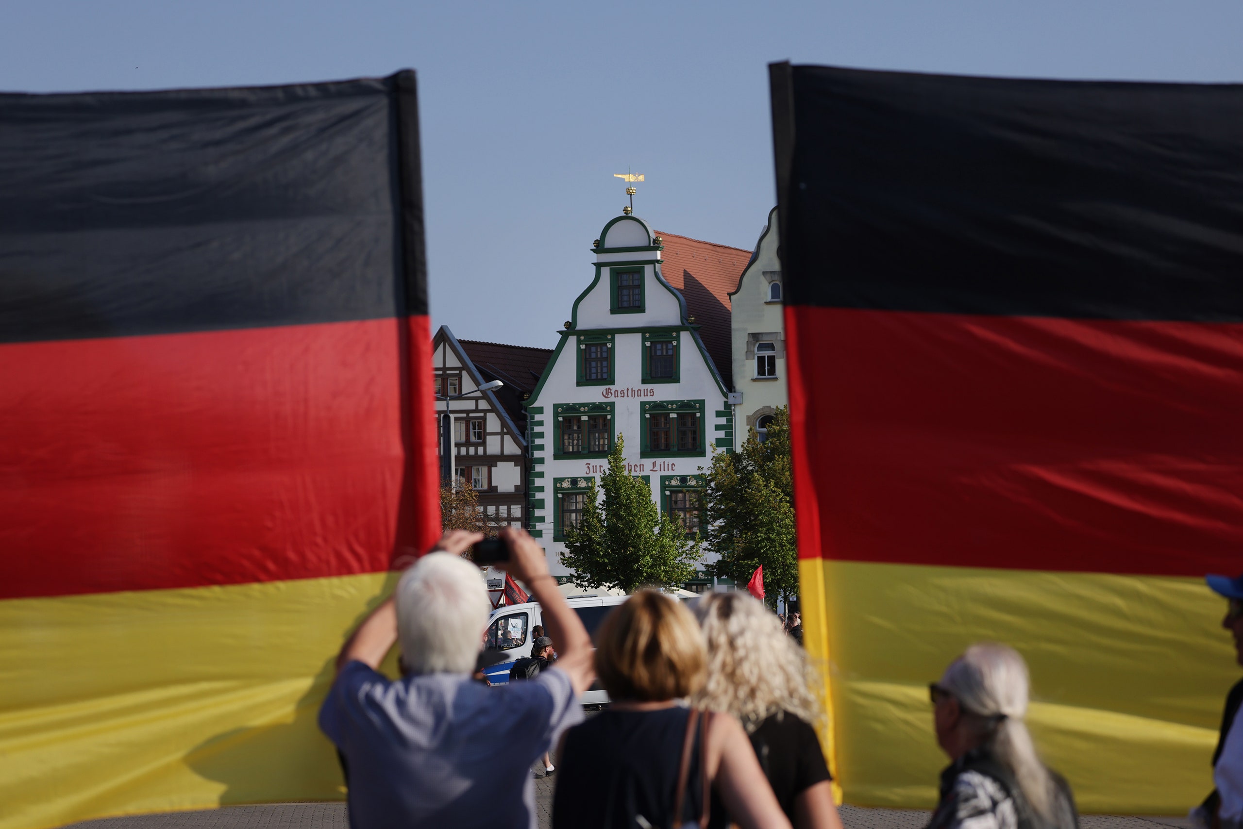 Supporters of the farright Alternative for Germany  political party stand with German flags at the final AfD campaign...