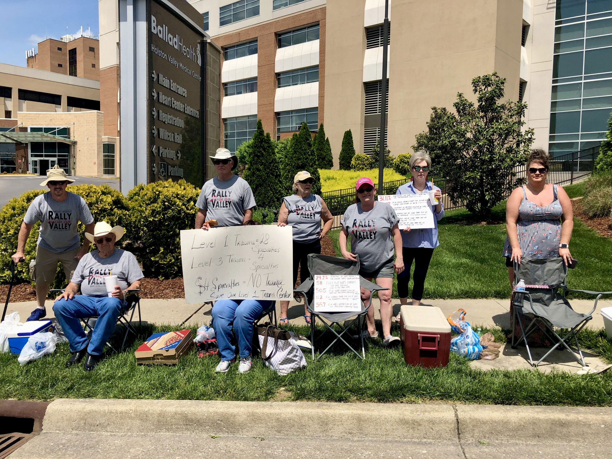 A photo of a group of people protesting outside of a hospital.