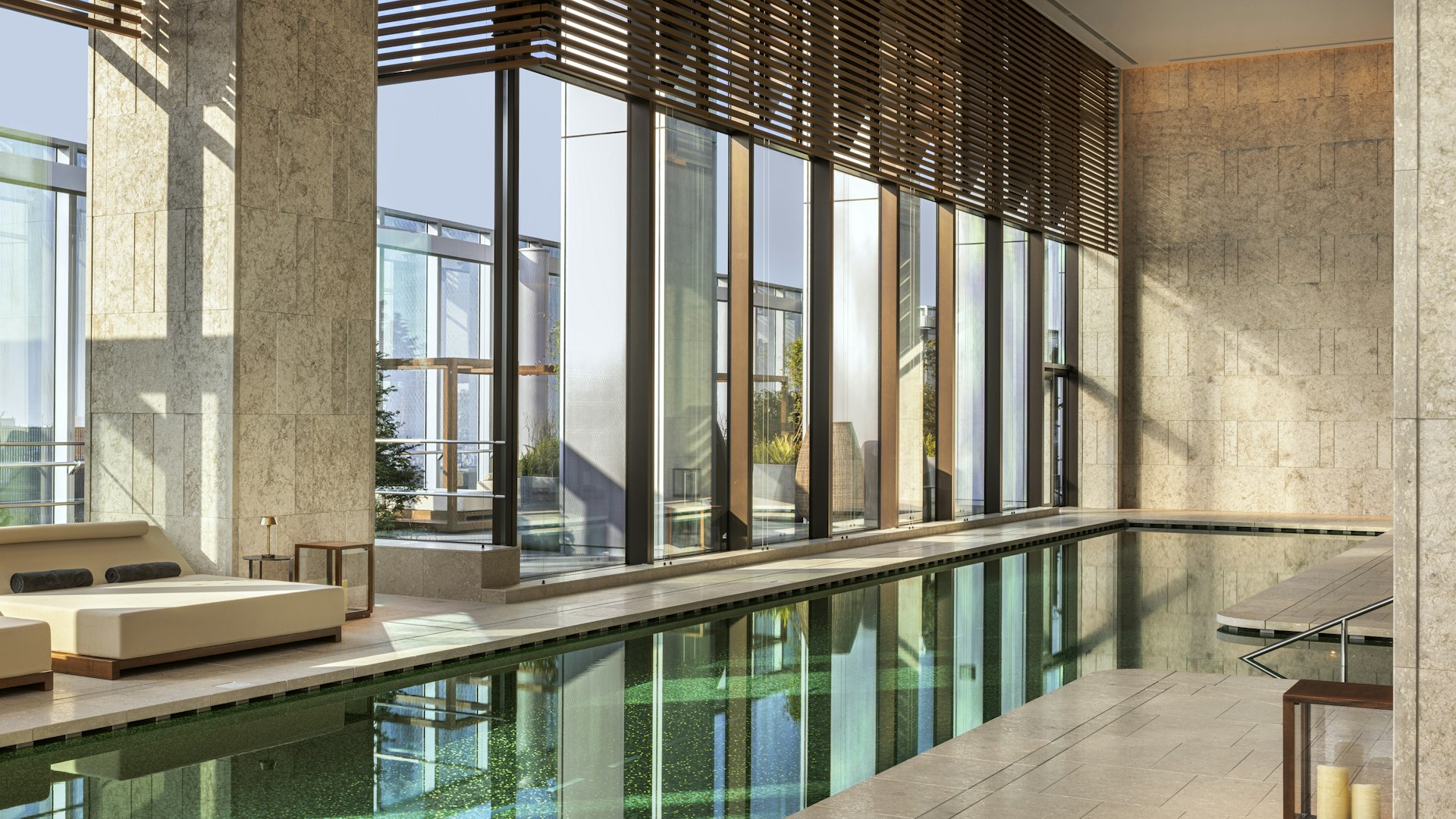 An indoor hotel pool with green tiling