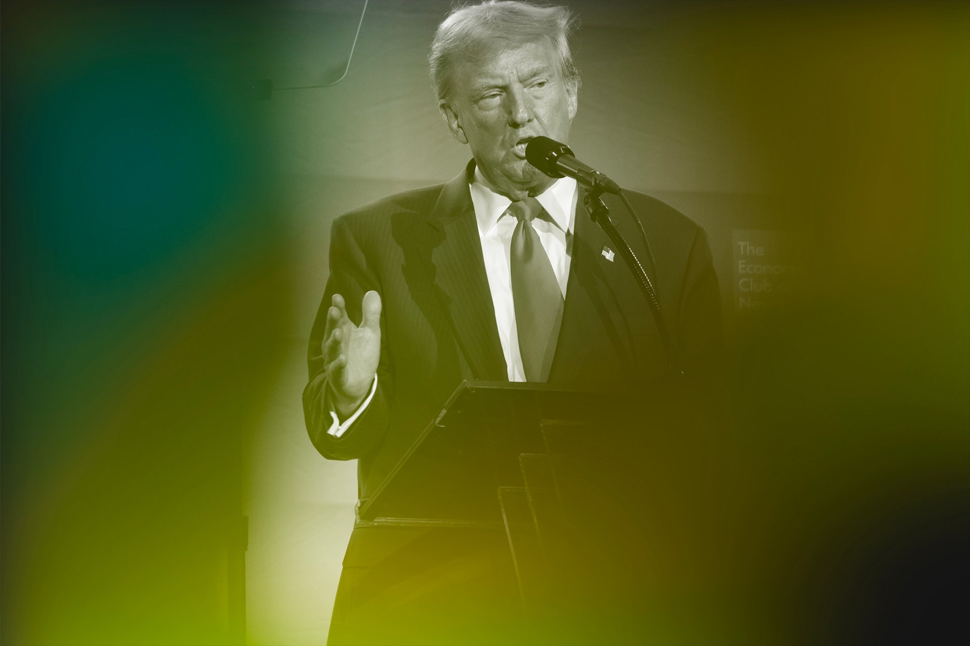 A photo of Donald Trump speaking from behind a podium and gesturing with one hand. There is a green tinted overlay on...