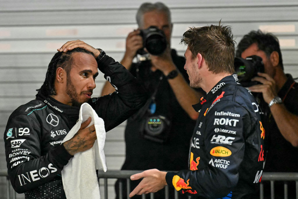 Mercedes' British driver Lewis Hamilton, left, speaks with Red Bull Racing's Dutch driver Max Verstappen, right.