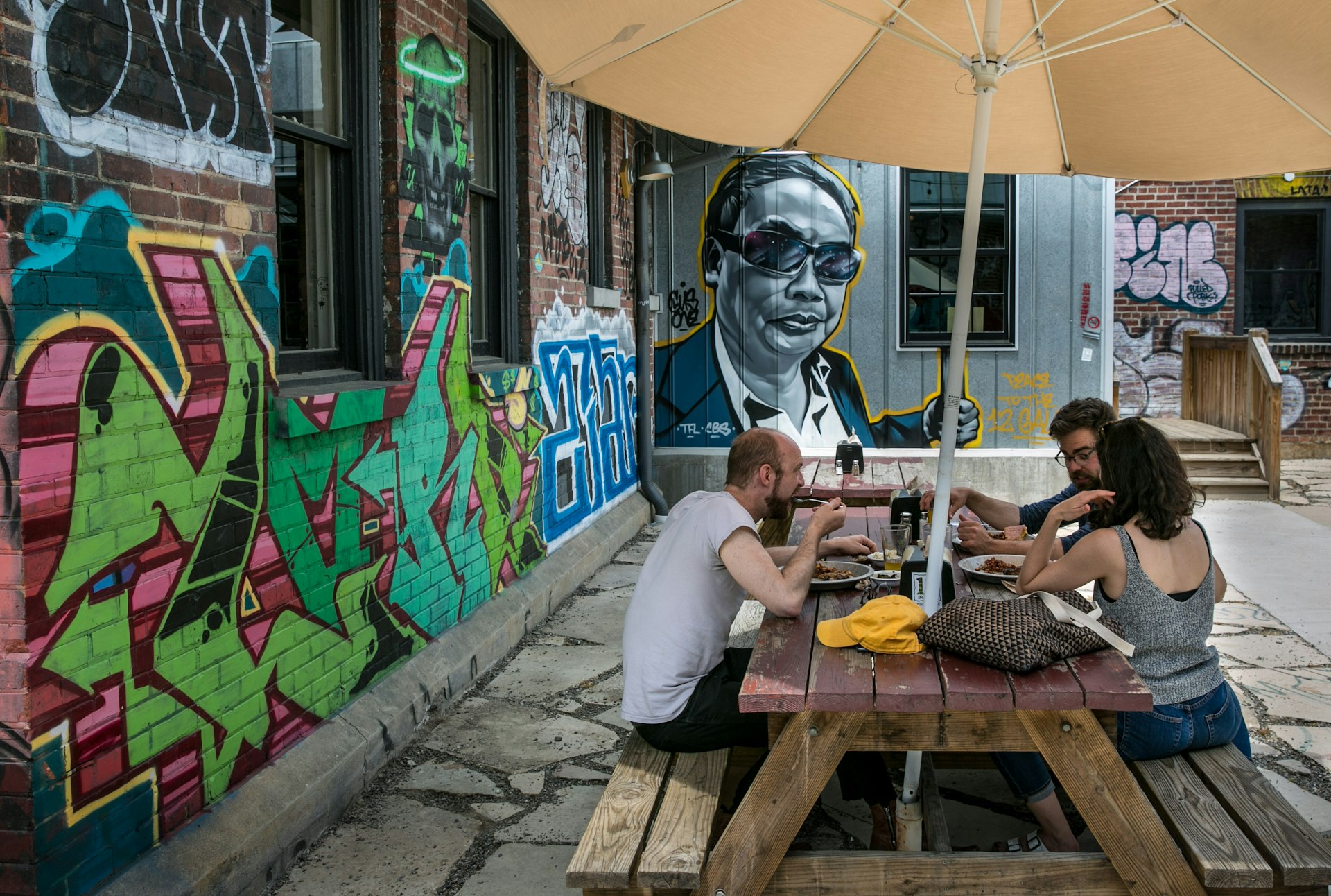 People enjoy the outside patio at 12 Bones Smokehouse barbecue restaurant in the River Arts District on May 11, 2018 in Asheville, North Carolina