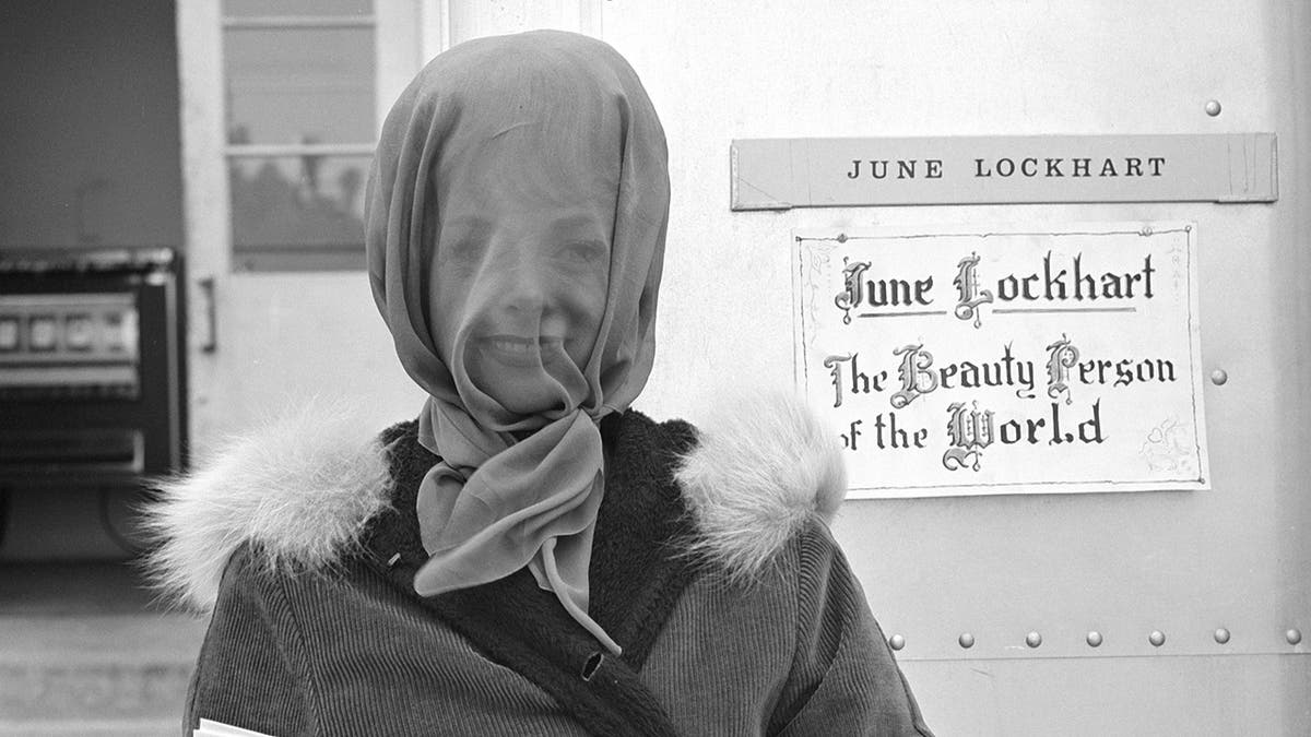 June Lockhart with her face covered on the set of Lost in Space