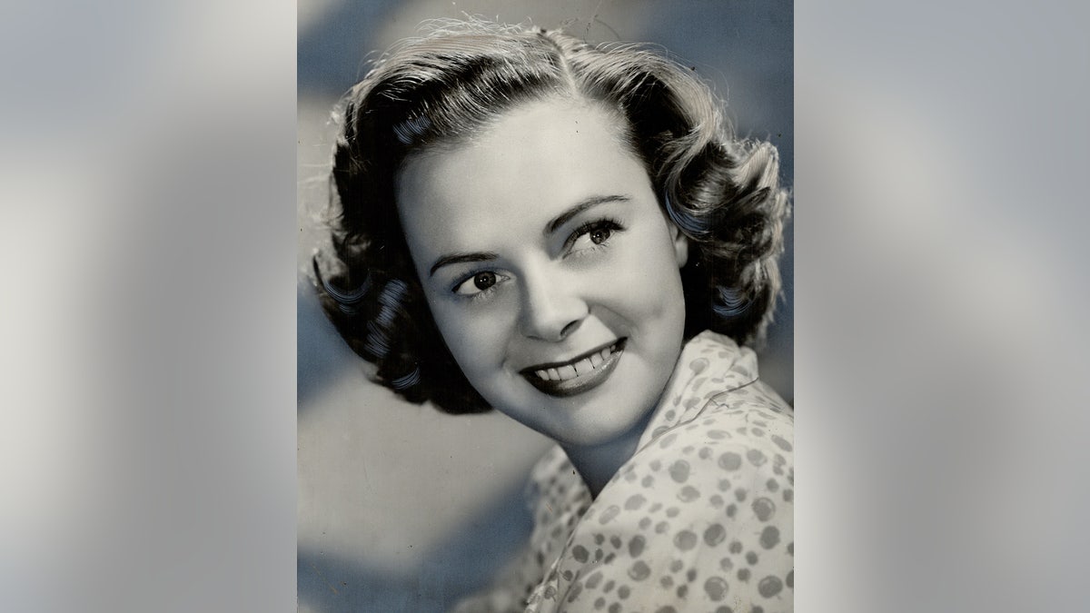 A young June Lockhart posing for a black and white photo