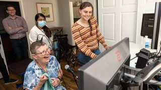 A woman with ALS uses a brain computer interface to brain activity, detected by sensors implanted above her cerebral cortex, to make words appear on a screen