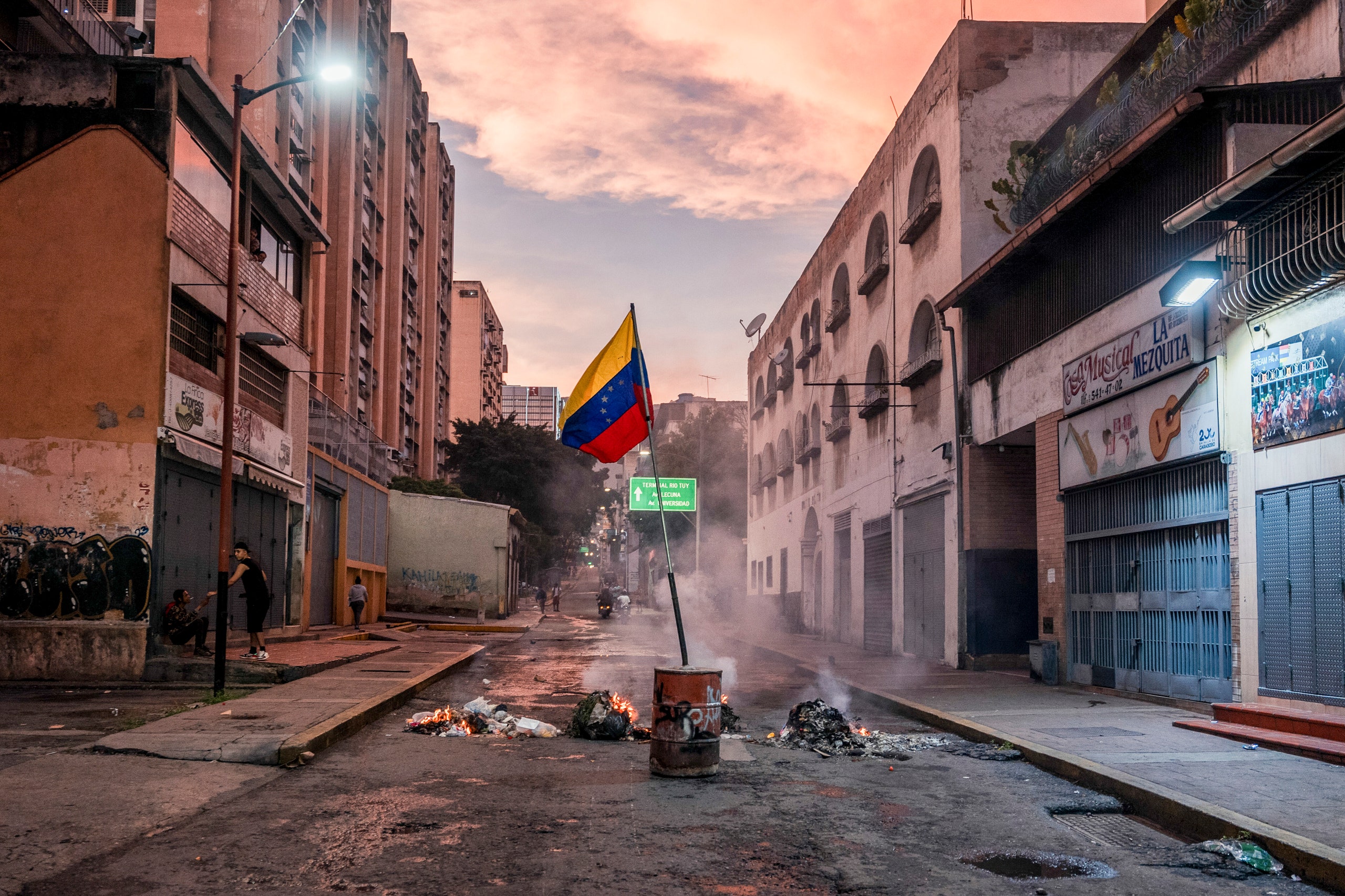 A Venezuelan flag in the middle of a street.