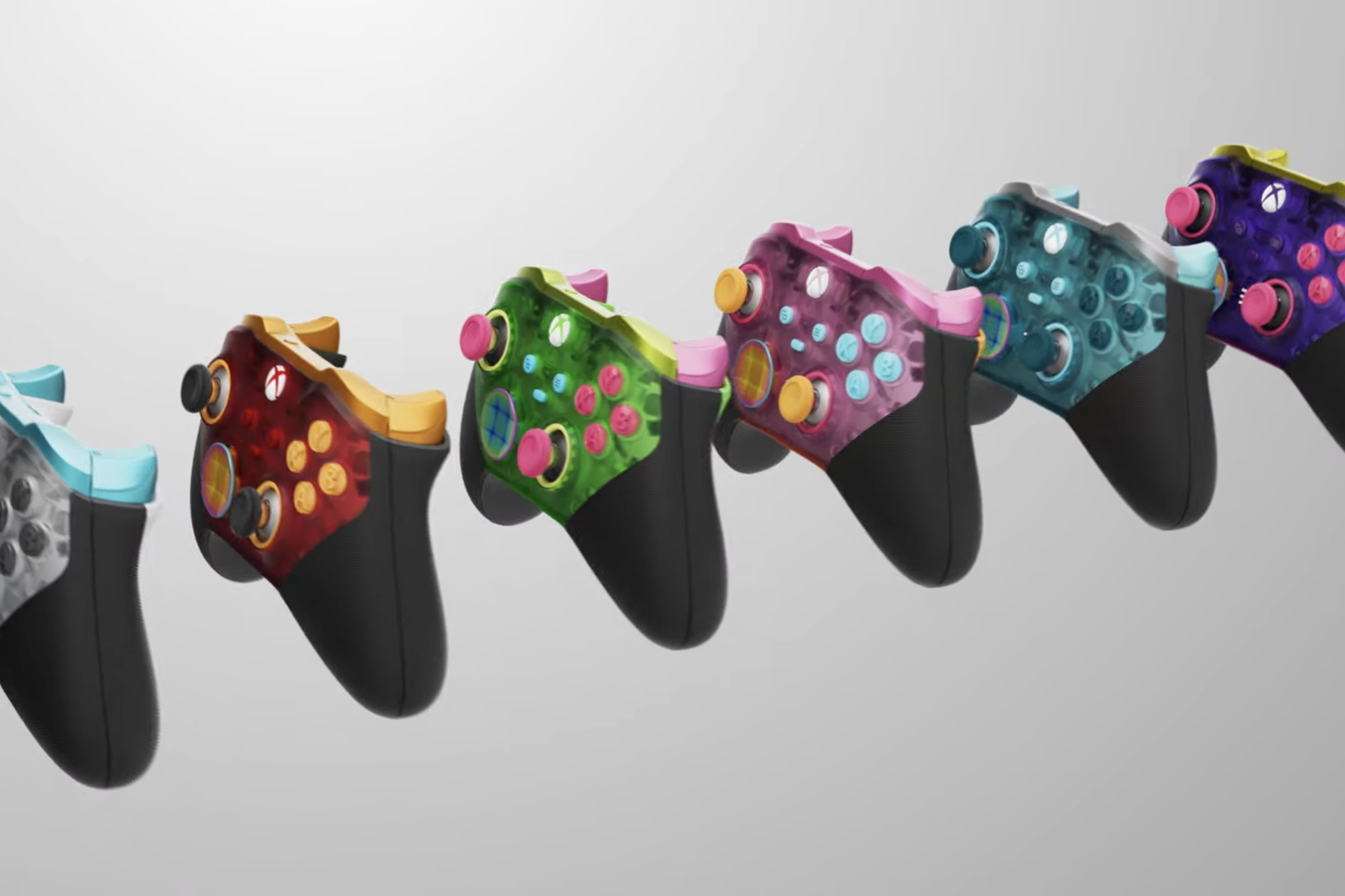 All of the new translucent controller options arrayed in a row, from left to right: white, red, green, pink, blue, and purple.