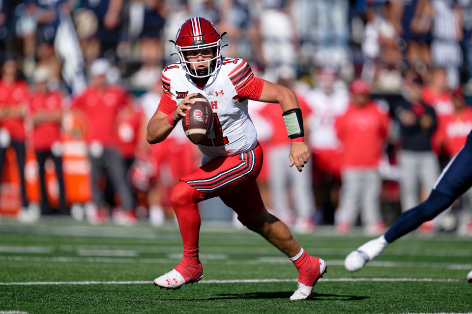 Sep 14, 2024; Logan, Utah, USA;  Utah Utes quarterback Isaac Wilson (11) runs with the ball against the Utah State Aggies at Merlin Olsen Field at Maverik Stadium. Mandatory Credit: Jamie Sabau-Imagn Images