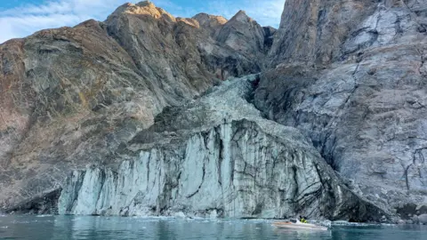 Wieter Boone A small research boat in front of a glacier in a fjord in Greenland 