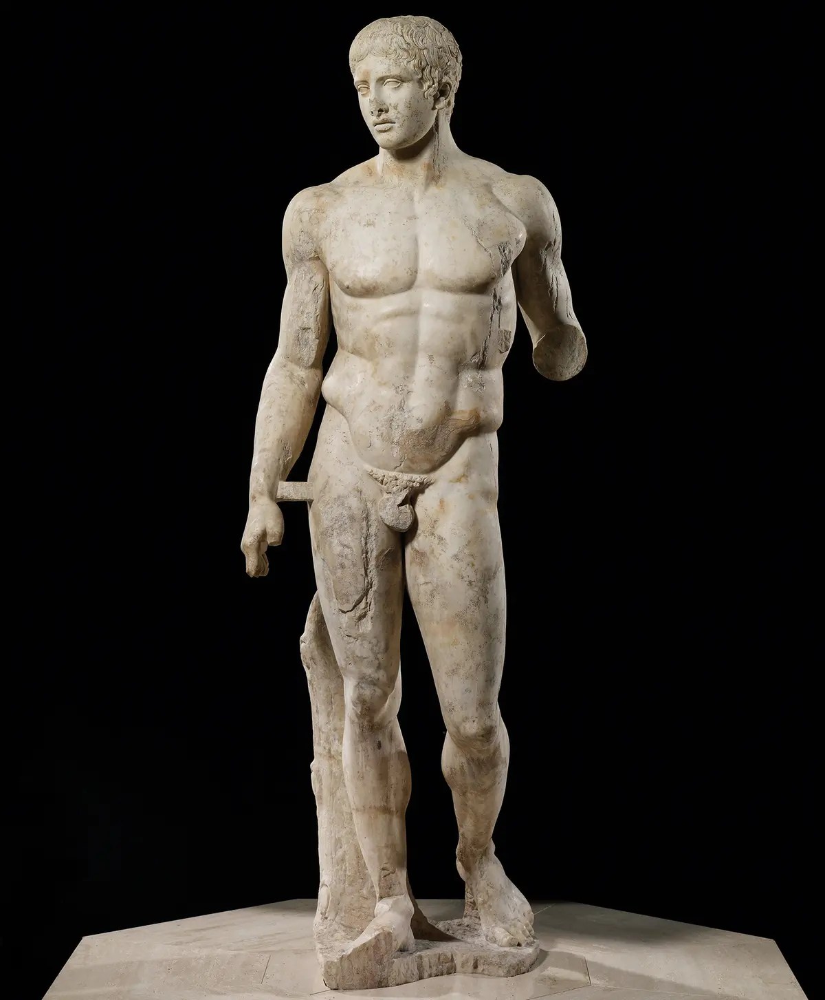 A marble stature of a very muscular man.