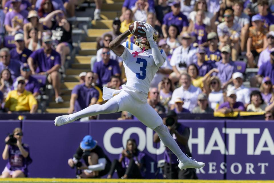 UCLA receiver Kwazi Gilmer leaps to make a catch