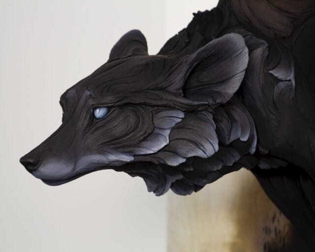 a detail of a clay sculpture featuring a dark fox-like creature