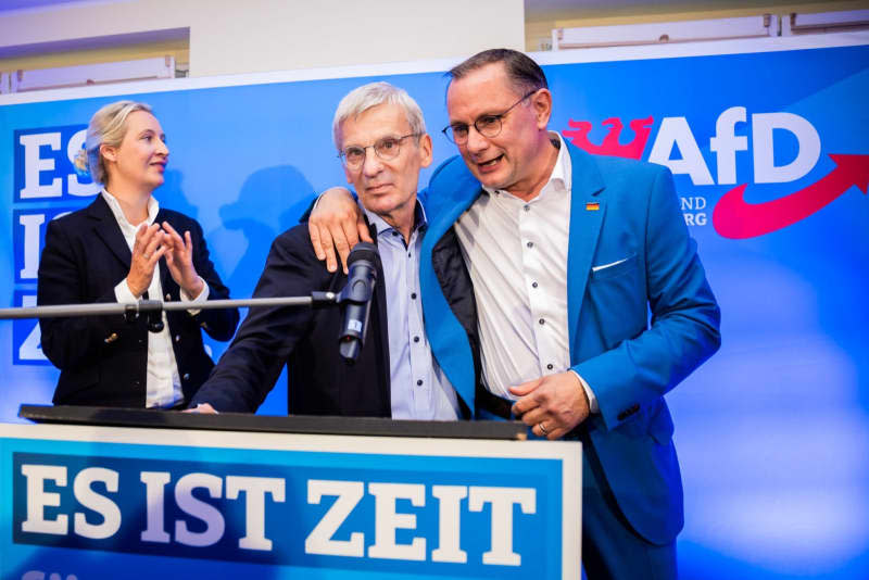 (L-R) Alice Weidel, national leader of the Alternative for Germany party (AfD), Hans-Christoph Berndt, deputy chairman and top candidate of the AfD Brandenburg, and Tino Chrupalla, AfD national leader, react to the first projections of the Brandenburg state elections at the Brandenburg AfD election party. Christoph Soeder/dpa