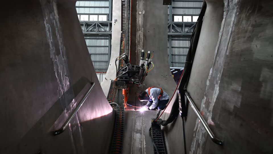 A staff member welds parts together at the CRAFT fusion research park in in Hefei, eastern China, in  September 2023. The BEST tokamak will be built next to CRAFT. - Xinhua/Shutterstock