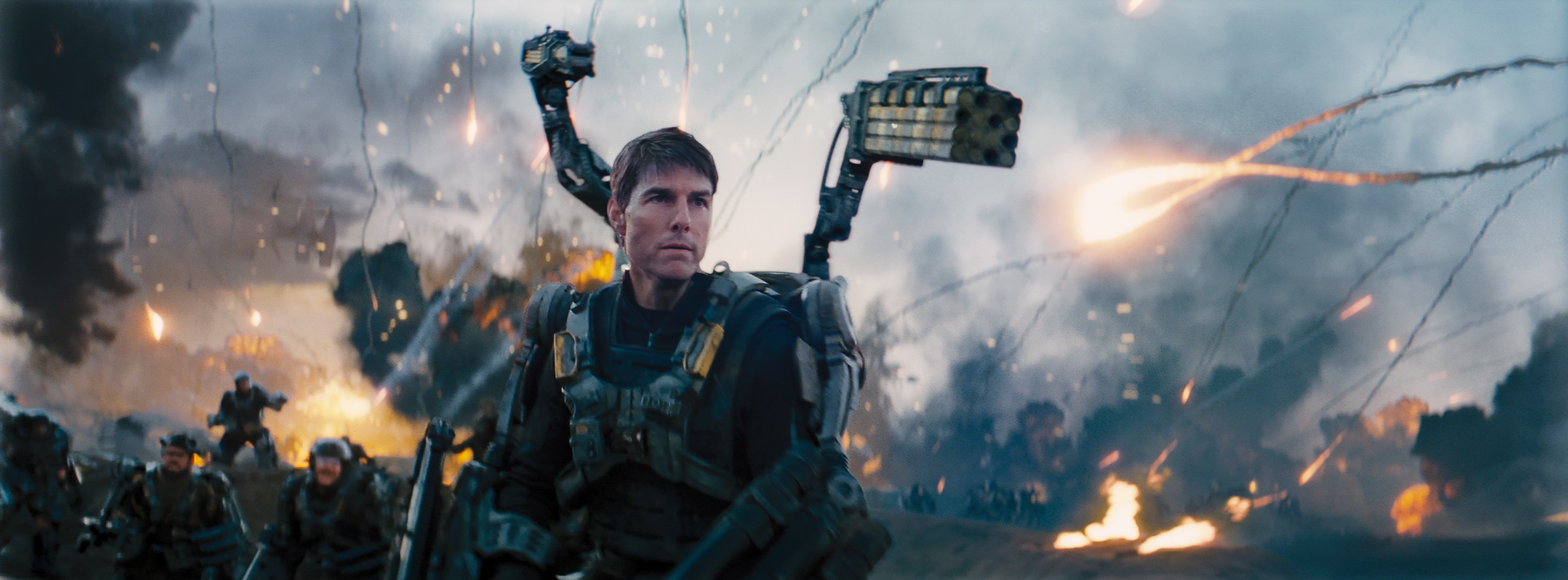 Tom Cruise in futuristic armor with guns in Edge of Tomorrow.