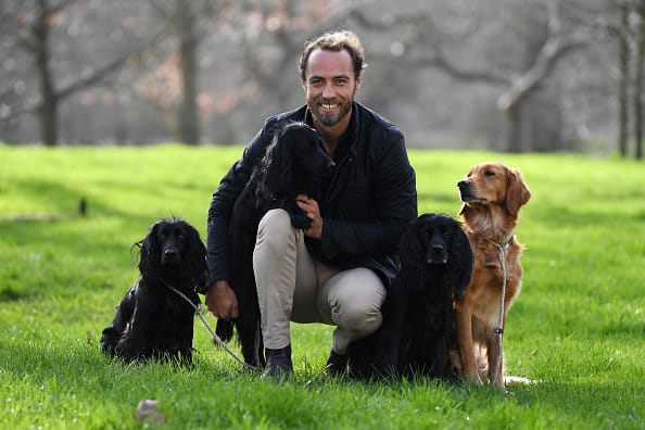 James Middleton poses for a photograph with his dogs Inka, Luna, Ella and Mabel.