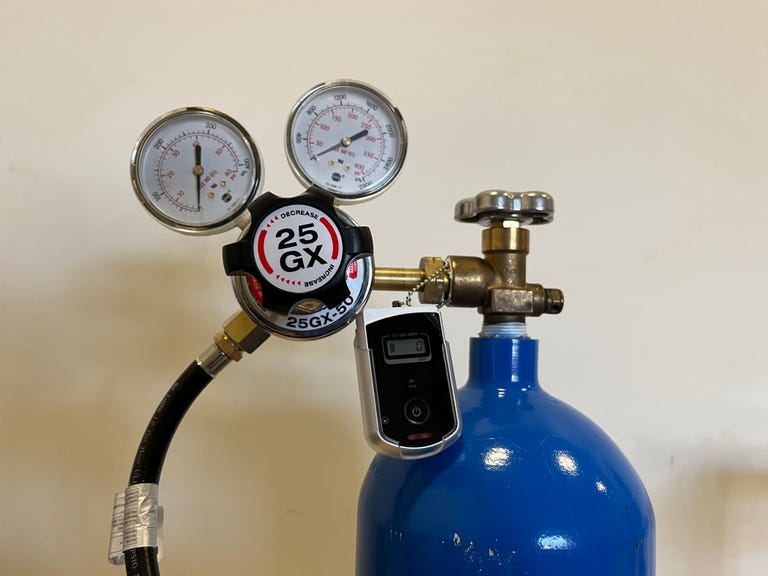 A close-up look at the gas regulator on the tank of carbon monoxide used in CNET's carbon monoxide detector tests. There's a portable CO alarm attached to the line to help detect any dangerous leaks during our test process.