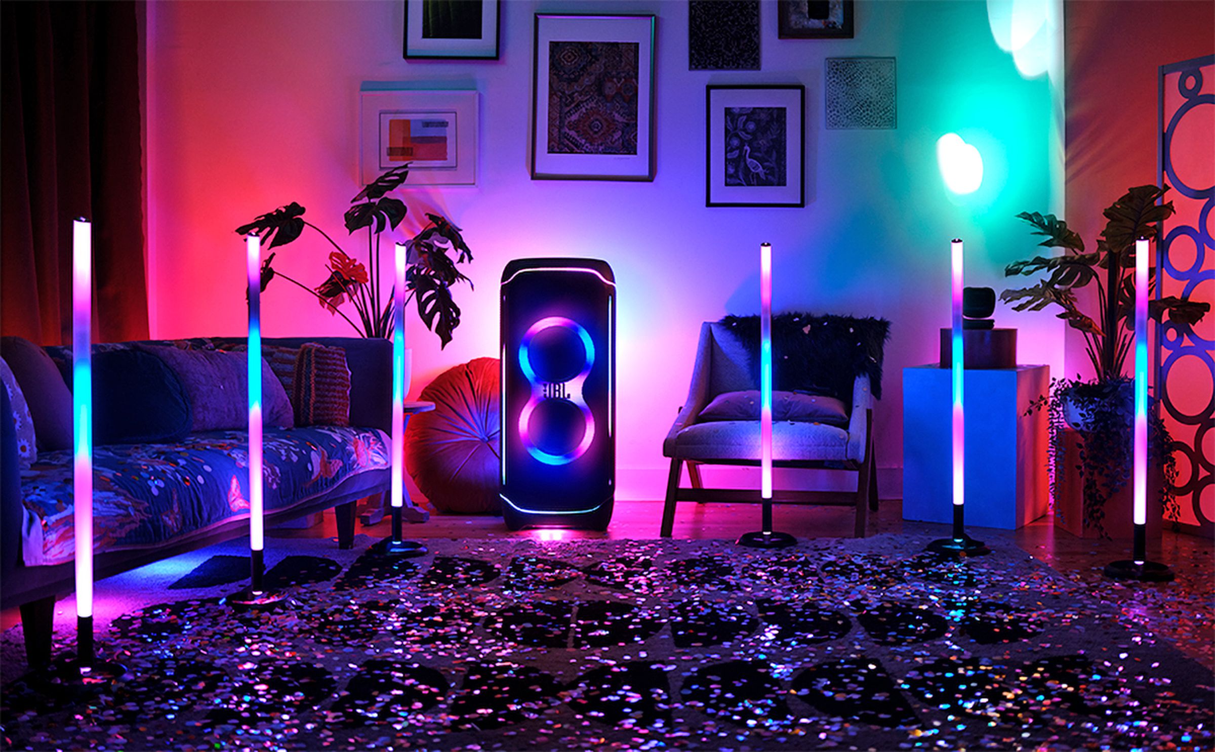 Several JBL PartyLight Sticks illuminating a small room.