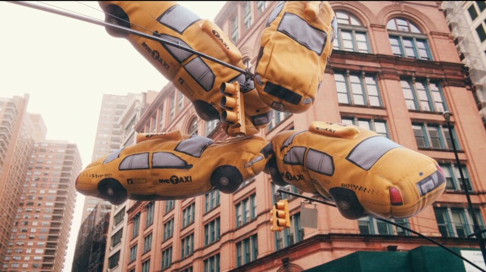 a still of four flying yellow taxis colliding in the air