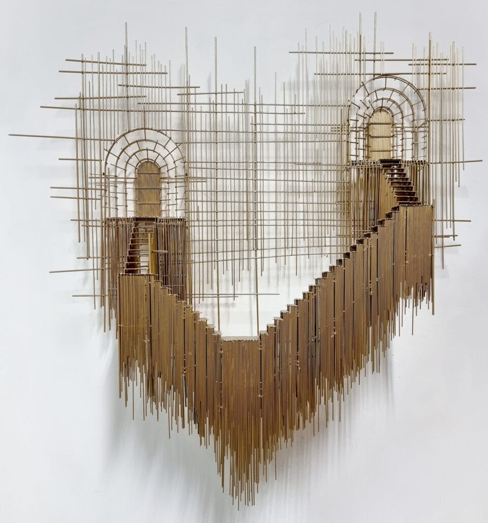 a wall sculpture made of numerous pieces of steel wire assembled in an abstract composition of stairs on gold scaffolding