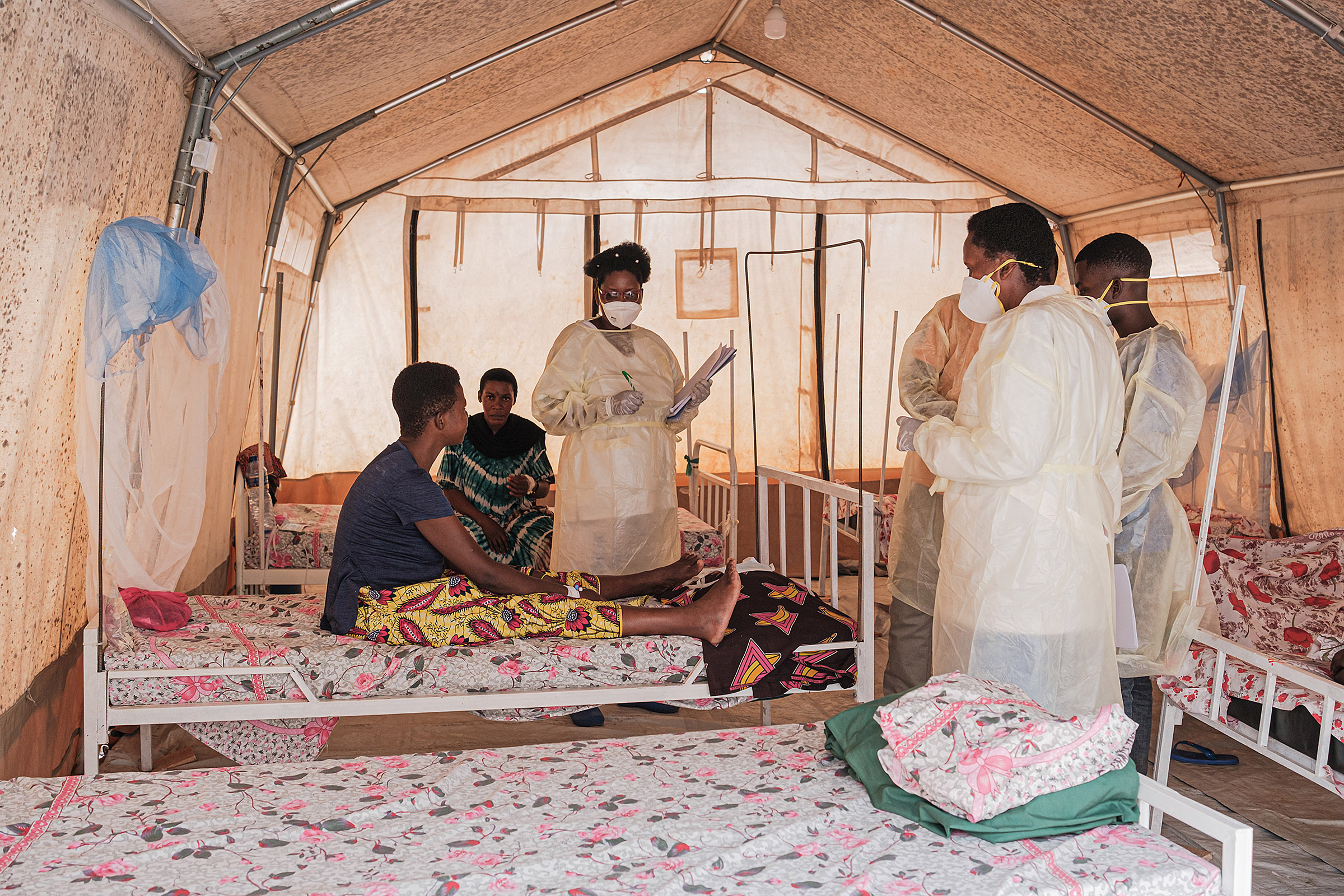 Health workers speak with patients inside a ward for women infected with Mpox at the Kamenge University Hospital's Mpox treatment center in Bujumbura, Burundi, on Aug. 22, 2024.