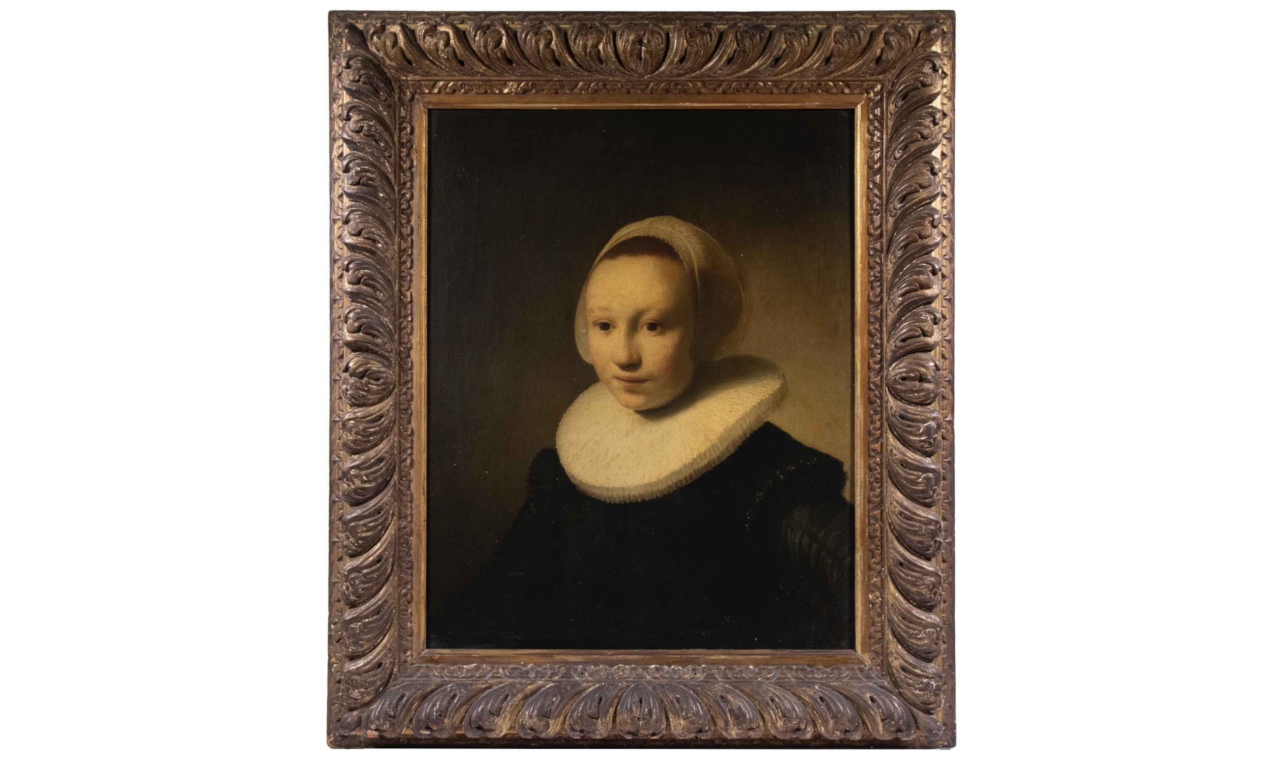 A portrait of a teenage girl dressed in austere black attire and housed in a Dutch gilt wood frame in the style of Rembrandt.