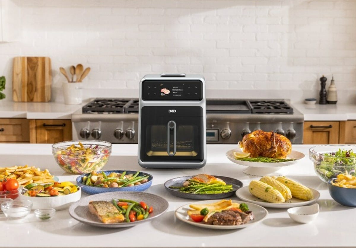 air fryer with food around it