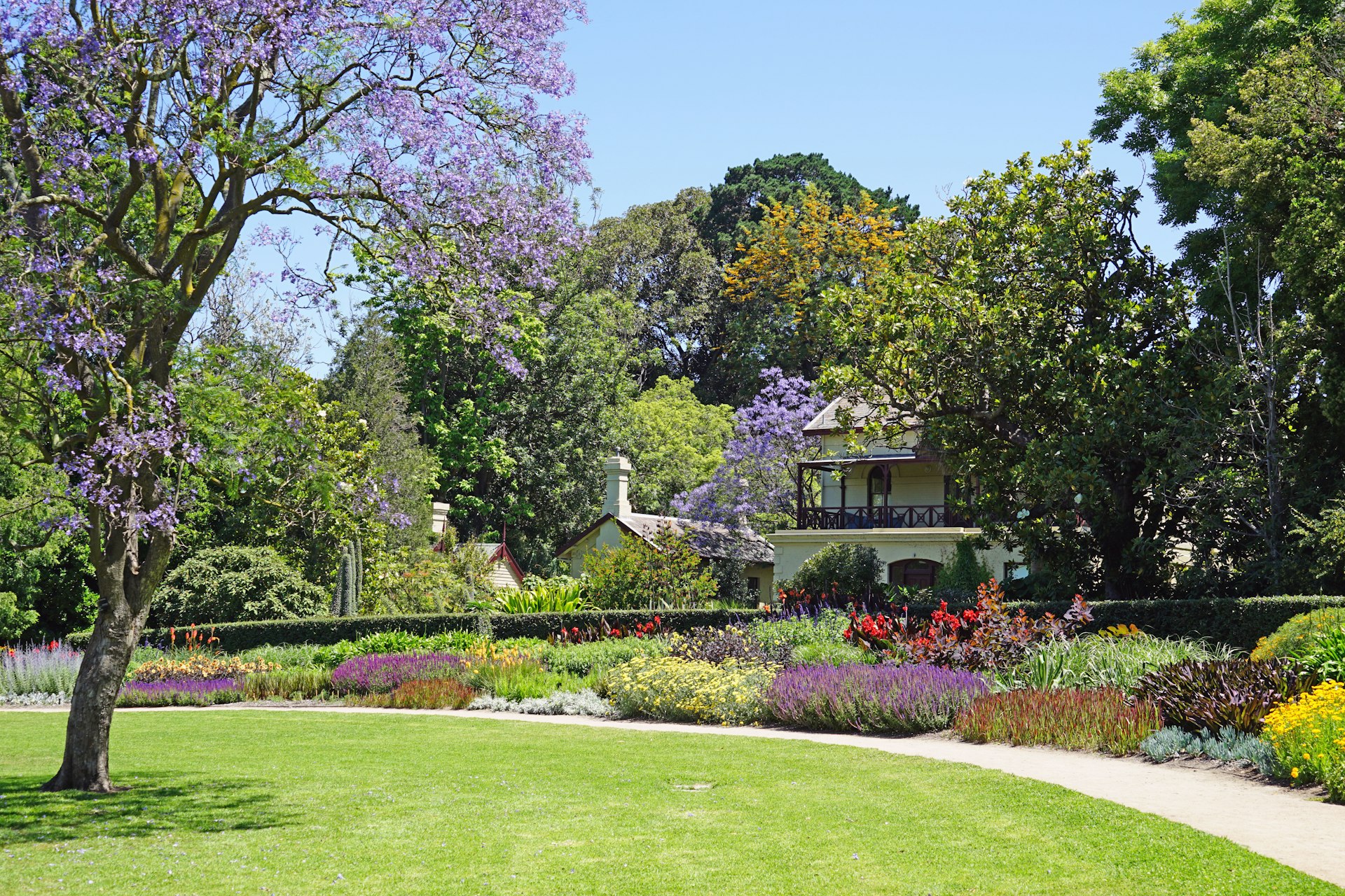 The Royal Botanic Gardens is located in the center of Melbourne by the Yarra River. It includes a herbarium and a children's garden.