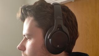 The SoundMagic P58BT ANC on a man's head.